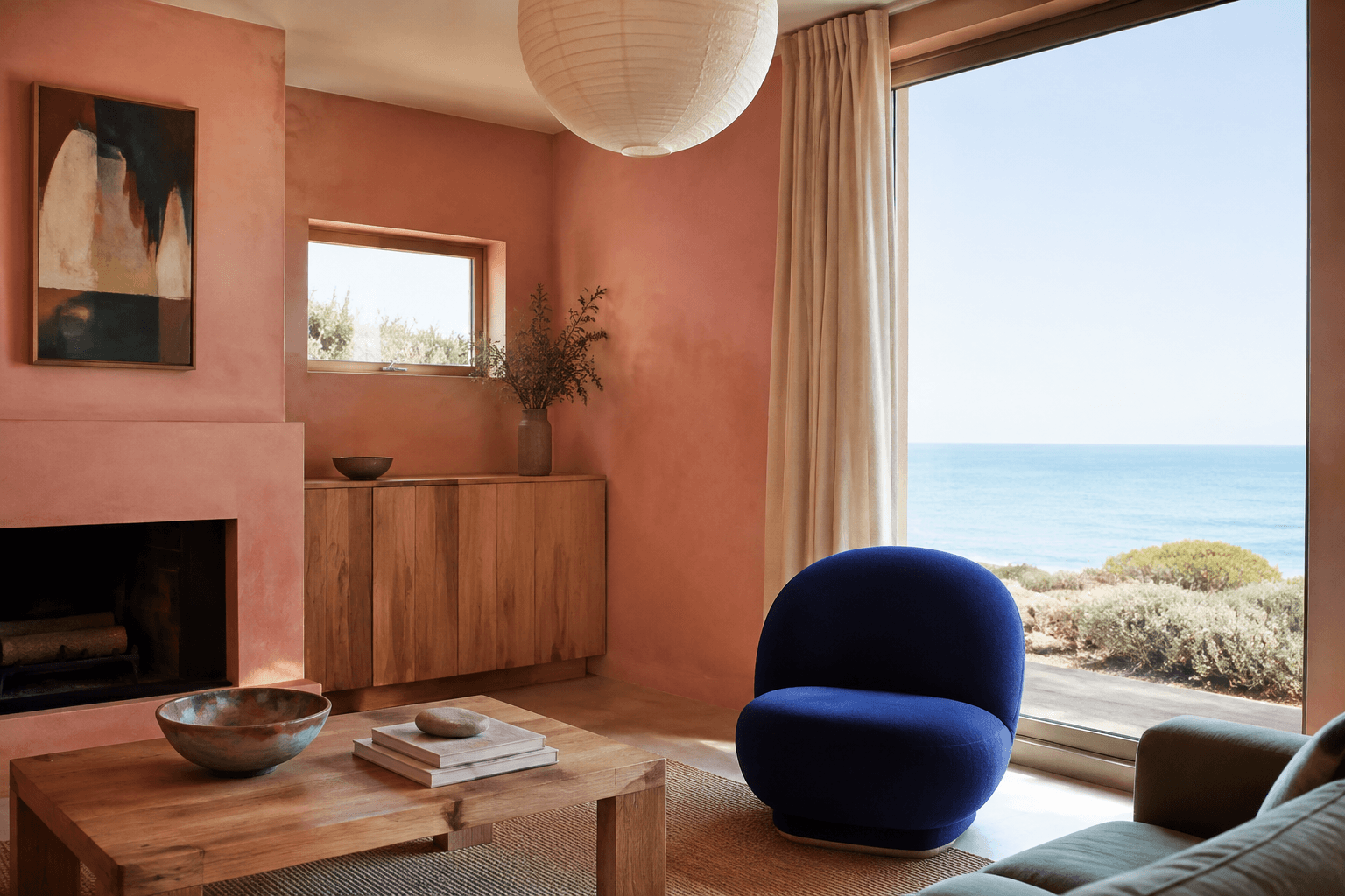 Coral living room walls with white ceiling and a cobalt chair